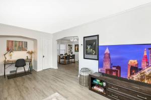 a living room with a large flat screen tv at Shaker Heights- WiFi, 1st Floor in Shaker Heights
