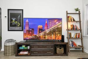 a living room with a flat screen tv on a stand at Shaker Heights- WiFi, 1st Floor in Shaker Heights