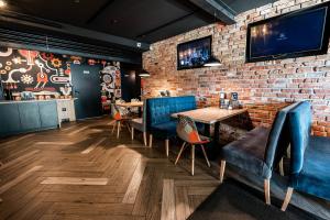 a restaurant with blue chairs and a brick wall at Willa ŻeglarSki in Kluszkowce