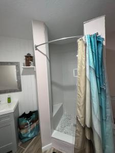 a shower with a glass door in a bathroom at La Mia Casa in Sarasota