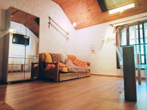 a living room with a couch in the corner of a room at 4th Floor Bardonecchia in Bardonecchia