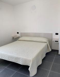 チロ・マリーナにあるCamping Village Torrenovaのベッドルーム(白いベッド、白いシーツ付)