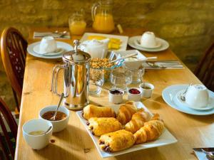 a table with pastries and other food on it at The Crown & Victoria Inn in Tintinhull