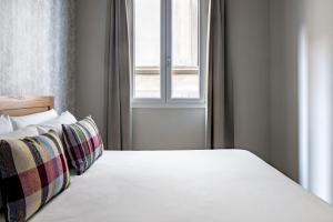 Posteľ alebo postele v izbe v ubytovaní Numa Florence Fiore