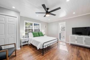 a bedroom with a bed and a ceiling fan at Private 1BR Cottage In Downtown Historic Norcross in Norcross