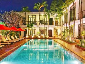 a large swimming pool in front of a building at The Bliss Angkor in Siem Reap