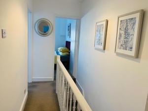 a hallway with a stairway leading to a bedroom at Salisbury Solace in Salisbury