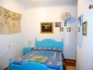 a bedroom with a blue bed in a room at Habitaciones La Pepa in Cádiz
