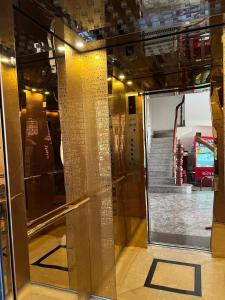 um elevador de vidro num edifício com uma escada em HOTEL SAO MAI địa chỉ 22D3 TRẦN QUANG KHẢI em Can Tho