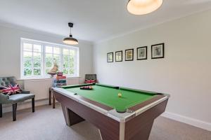 a living room with a pool table in it at St George's - stylish family home in Sandwich in Kent