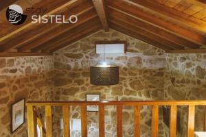 a ceiling of a room with a stone wall at Casa da Carreirinha in Arcos de Valdevez