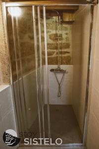 a shower with a glass door in a bathroom at Casa da Carreirinha in Arcos de Valdevez