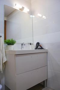 a white bathroom with a sink and a mirror at YourPlace - 2BR - Agdal - Av France in Rabat