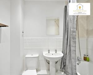 a white bathroom with a toilet and a sink at Beautiful 2 Bedroom Seviced Apt in Aylesbury By Sambridge Stays Short Lets & Serviced Accommodation in Aylesbury