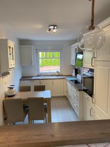 a kitchen with a table and chairs and a dining room at Rose Garden in Hessisch Oldendorf