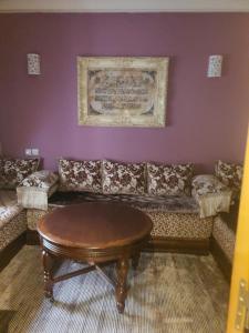 a living room with a couch and a table at Résidence les champs N3 in Casablanca