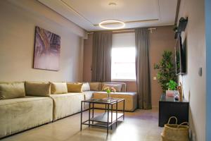 a living room with a couch and a table at YourPlace - 2BR - Agdal - Av France in Rabat