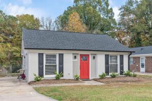a small white house with a red door at Cozy 3BR home fully fenced and in quiet street, 5min to downtown, 10min to Duke and RTP in Durham