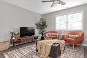 a living room with two chairs and a television at Cozy 3BR home fully fenced and in quiet street, 5min to downtown, 10min to Duke and RTP in Durham