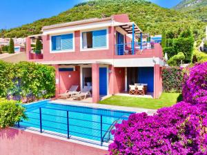 a villa with a swimming pool and a house at Villa Barbati Pelagos with private pool by DadoVillas in Barbati