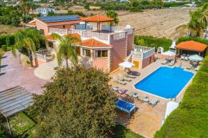 an aerial view of a house with a swimming pool at Villa Polyxeni in Peyia