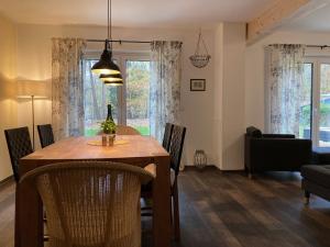 a dining room with a table and chairs and a living room at Ferienhaus am Hafen in Klausdorf Mecklenburg Vorpommern