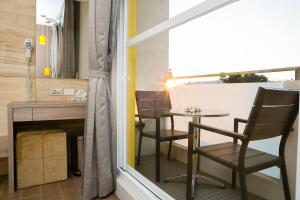 a small table and chairs in a room with a window at Bai Sha Tan Cottage in Kenting