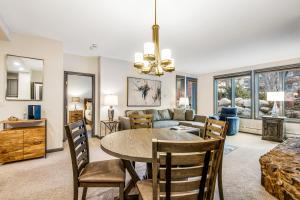 a dining room and living room with a table and chairs at Arrowhead Ski Condo in Edwards