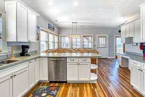 a kitchen with white cabinets and stainless steel appliances at The Pink Flamingo in Avon