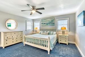 a bedroom with a bed and a ceiling fan at The Pink Flamingo in Avon