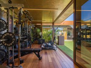 a gym with treadmills and a large window at Villa Kai by Maspalomas Holiday Villas in Pasito Blanco