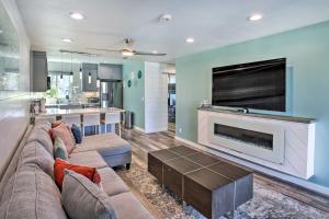 a living room with a couch and a fireplace at Waterfront Huntington Beach Condo with Fire Pit in Huntington Beach