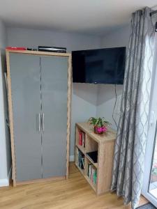 a room with a white door and a tv on a wall at Sea View Studio in Castlerock