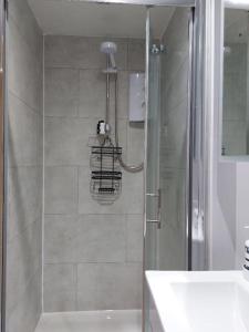 a bathroom with a shower and a sink at Sea View Studio in Castlerock