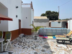 a patio with a pool on top of a building at The Compound in Bijilo