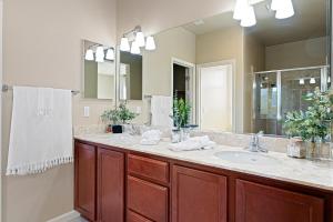 a bathroom with a sink and a large mirror at High End Midtown Home With Fireplace And Ensuite Baths in Reno