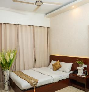 a bedroom with two beds and a window at Laguna Beach Hotel & Resort in Cox's Bazar