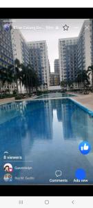 a picture of a swimming pool in front of some buildings at Sea res Mall of Asia 2bedroom by Elsie D in Manila