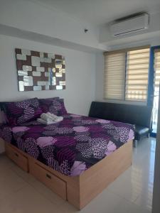 Ένα ή περισσότερα κρεβάτια σε δωμάτιο στο Sea res Mall of Asia 2bedroom by Elsie D