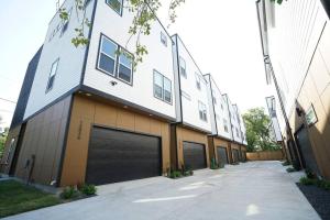 a building with two garage doors on the side of it at Pet Friendly Stylish 4 Bedroom home Close to All in Houston