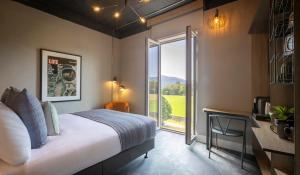 a bedroom with a large bed and a large window at Hotel67 in Killarney