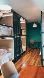 a room with two bunk beds and a table at Bendito Hostels in Bogotá