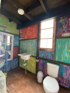 a bathroom with a toilet and a sink at Casa Tongoy Península in Coquimbo