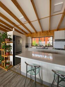 a kitchen with a counter and two stools at Casa Tongoy Península in Coquimbo