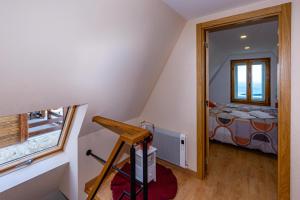 una piccola camera mansardata con letto e finestra di Bungalow QJ a Covilhã