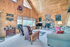 a living room with a couch and a fireplace at Secluded Lost Lake Cottage with Spacious Loft! in Hawks