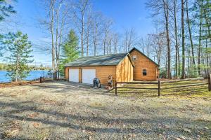 a barn with a horse standing in front of it at Secluded Lost Lake Cottage with Spacious Loft! in Hawks