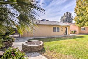 a house with a fire pit in the yard at Kingsburg Home with Patio about 22 Mi to Fresno! in Kingsburg