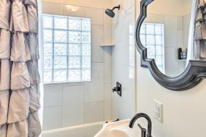 a bathroom with a sink and a mirror at South Bend Home Less Than 1 Mi to Notre Dame! in South Bend +18 photos