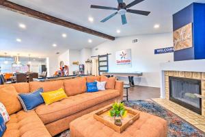 a living room with a couch and a fireplace at San Antonio Home with Hot Tub and Arcade Games! in San Antonio